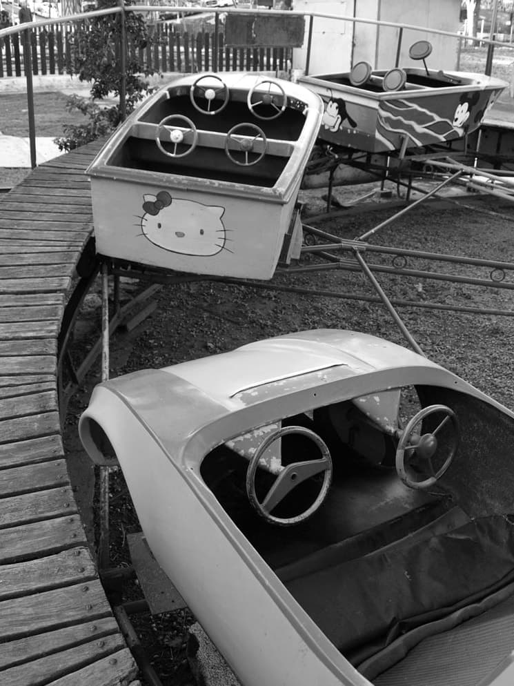 Small cars of a children's fairground ride, still and empty